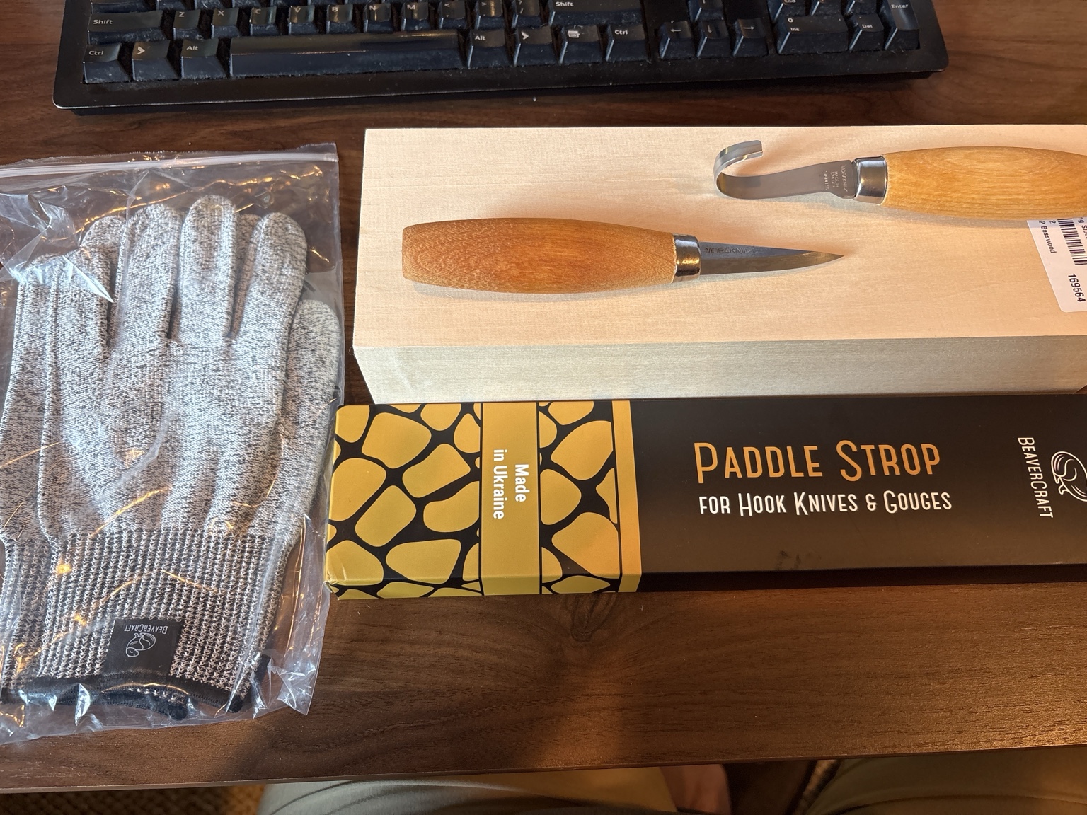 Mora carving knives, a strop, cut-resistant gloves, and basswood blanks.