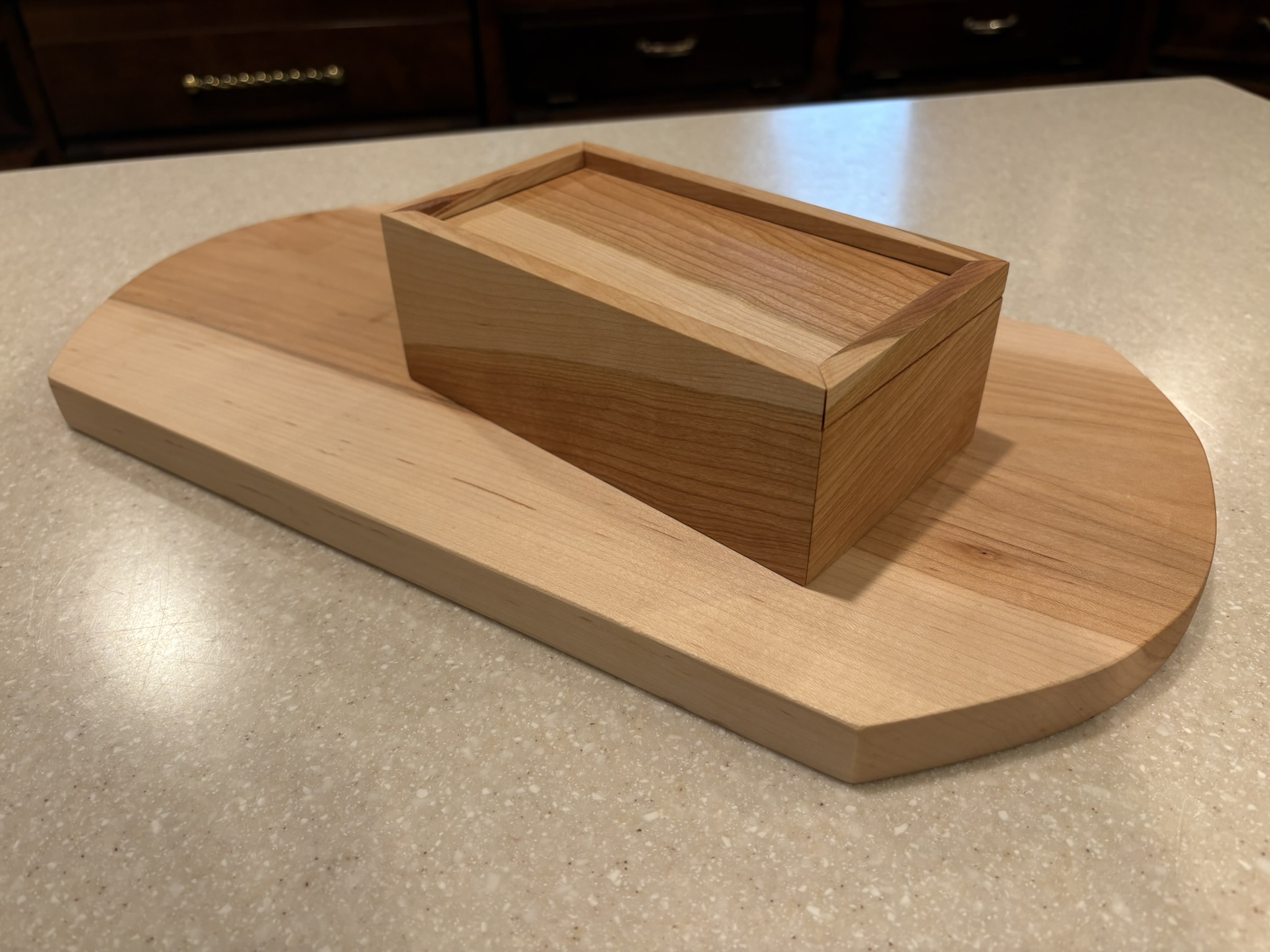Maple cutting board and cherry slide-top box made during the woodworking class.