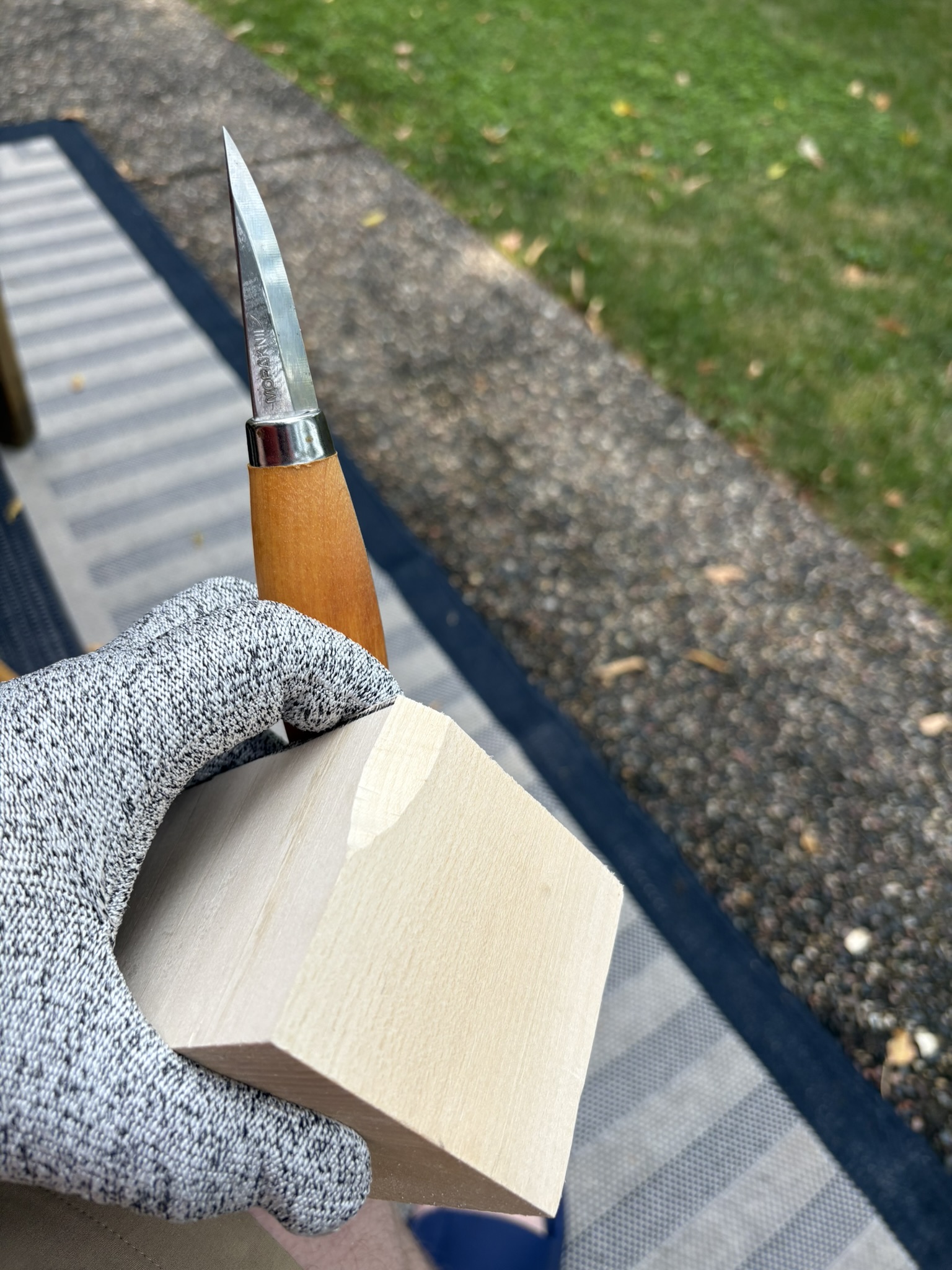 A first cut into a basswood blank with a carving knife.